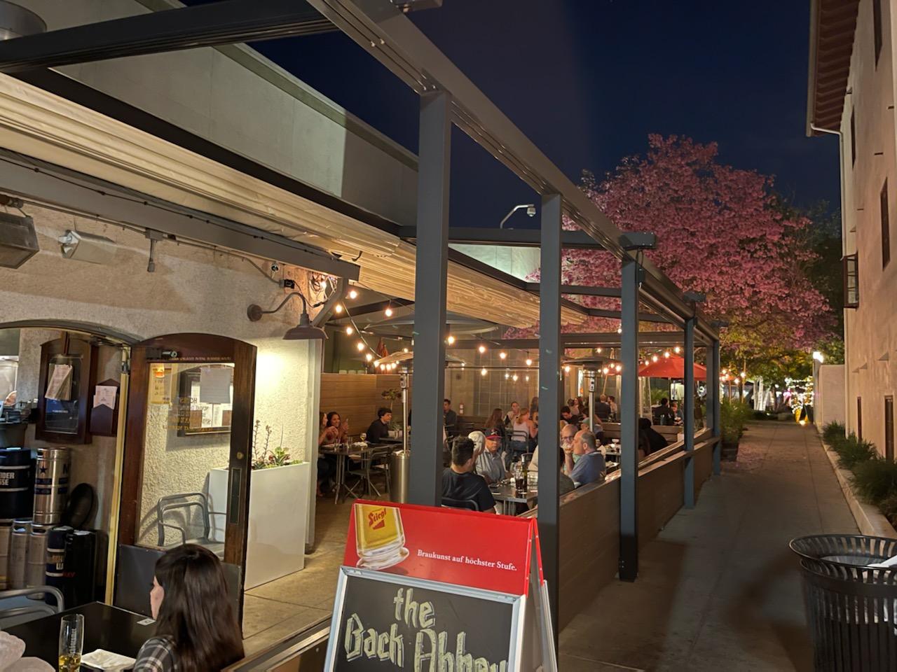 The Back Abbey's patio at night, strung with lights and full of diners